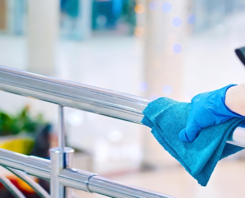 Person cleaning handrail