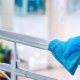 Person cleaning handrail